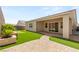 Charming backyard featuring artificial turf, a putting green, and a covered patio at 3391 Stone View Ave, Henderson, NV 89044
