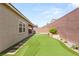 Spacious backyard featuring artificial turf, a putting green, and a neutral exterior at 3391 Stone View Ave, Henderson, NV 89044