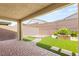 Inviting backyard with artificial turf, a putting green, and a covered patio area at 3391 Stone View Ave, Henderson, NV 89044