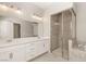 Bathroom featuring double sinks, a glass shower enclosure, and a soaking tub at 3391 Stone View Ave, Henderson, NV 89044