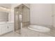 Well-lit bathroom with a walk-in shower next to a soaking tub at 3391 Stone View Ave, Henderson, NV 89044