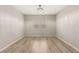 Spacious bedroom featuring wood-look floors, neutral walls, and a decorative light fixture at 3391 Stone View Ave, Henderson, NV 89044