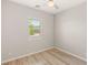 An empty bedroom with light walls and wood-look flooring at 3391 Stone View Ave, Henderson, NV 89044
