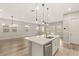 Open-concept kitchen with island, stainless steel appliances, and modern pendant lighting at 3391 Stone View Ave, Henderson, NV 89044