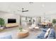 Virtually staged open-concept living space with modern furnishings and access to the dining area and kitchen at 3391 Stone View Ave, Henderson, NV 89044