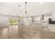 Open-concept living area with hardwood floors, designer lighting, and access to the kitchen at 3391 Stone View Ave, Henderson, NV 89044
