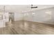 Spacious open-concept with hardwood floors, modern lighting, and a view of the kitchen island at 3391 Stone View Ave, Henderson, NV 89044