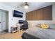 Relaxing bedroom with mounted TV, accent wall, study space, and cozy sleeping quarters at 405 Box Elder Way, Henderson, NV 89015