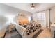 Cozy bedroom featuring a plush bed, neutral tones, and lots of natural light at 405 Box Elder Way, Henderson, NV 89015