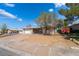 Street view of a cozy single-story home with xeriscaping, a two-car garage and covered patio at 405 Box Elder Way, Henderson, NV 89015