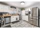 Bright kitchen with stainless steel appliances, white cabinetry, and stylish backsplash at 405 Box Elder Way, Henderson, NV 89015