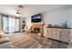 Inviting living room with brick fireplace, decorative furnishings, and sliding glass doors to the backyard at 405 Box Elder Way, Henderson, NV 89015