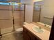 Bathroom featuring a shower with glass doors and a pink-tiled vanity area at 5401 Painted Sunrise Dr, Las Vegas, NV 89149