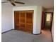 Spacious bedroom with neutral carpeting and a large closet with wood-finished doors at 5401 Painted Sunrise Dr, Las Vegas, NV 89149