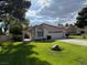 Well-maintained home with a tile roof, green lawn, and manicured landscaping at 5401 Painted Sunrise Dr, Las Vegas, NV 89149