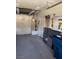 Functional garage interior with concrete floor and visible storage racks and water heater at 5401 Painted Sunrise Dr, Las Vegas, NV 89149