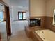 Main bath boasts corner jetted tub, double-sided fireplace, walk-in closet and large windows at 5401 Painted Sunrise Dr, Las Vegas, NV 89149