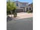 Charming two-story home with a tile roof, arched entry, and a two-car garage at 600 Our Heritage St, Henderson, NV 89011