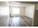 Bright living room features wood-style floors and a large window at 605 S Royal Crest Cir # 8, Las Vegas, NV 89169