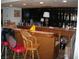 Home bar area with wood paneling, mirrored backdrop, and a seating area perfect for entertaining at 6325 Burgundy Way, Las Vegas, NV 89107