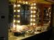 Bathroom with a large vanity and shelving, a lighted mirror, and a sink at 6325 Burgundy Way, Las Vegas, NV 89107