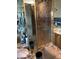 Bathroom with patterned tile, glass shower, and gold fixtures at 6325 Burgundy Way, Las Vegas, NV 89107