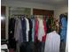 Clothes hang on the rack, with wood doors and a mirror in the background at 6325 Burgundy Way, Las Vegas, NV 89107
