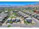 A high-angle aerial of a vibrant community featuring lush landscaping at 689 Rogue Wave St, Las Vegas, NV 89138