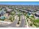 Neighborhood aerial shot highlighting landscaped streets, pools, and home exteriors with mountain views in the background at 689 Rogue Wave St, Las Vegas, NV 89138