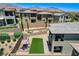 Elevated backyard showcasing pergola, lush synthetic grass, and outdoor patio at 689 Rogue Wave St, Las Vegas, NV 89138