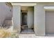 Inviting front entry featuring a cozy tiled porch with seating and covered access at 689 Rogue Wave St, Las Vegas, NV 89138