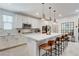 Modern kitchen featuring a large island with seating and stainless steel appliances at 689 Rogue Wave St, Las Vegas, NV 89138