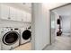 Bright laundry room with lots of storage cabinets and updated washer and dryer at 689 Rogue Wave St, Las Vegas, NV 89138