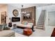 Stylish living area featuring modern décor, electric fireplace, and direct access to stairway at 689 Rogue Wave St, Las Vegas, NV 89138