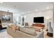 Comfortable living room featuring a plush sofa, modern decor, and ample natural light at 689 Rogue Wave St, Las Vegas, NV 89138
