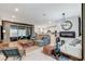 Open living room with modern furnishings, fireplace, and seamless transition to outdoor patio at 689 Rogue Wave St, Las Vegas, NV 89138