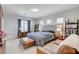 Serene main bedroom with a upholstered headboard, lounge area, and modern accents at 689 Rogue Wave St, Las Vegas, NV 89138