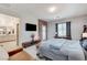 Main bedroom featuring brick accent wall, access to the outdoors and a glimpse into the primary bath at 689 Rogue Wave St, Las Vegas, NV 89138