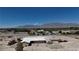 Expansive property featuring a home, RV, vehicles, and mountain views at 7130 Bilpar Rd, Las Vegas, NV 89131
