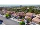 Neighborhood aerial view highlighting well-manicured homes with tile roofs, desert landscaping, and tree-lined streets at 7329 Restful Springs Ct, Las Vegas, NV 89128