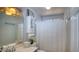 Bathroom featuring a shower with curtain, white cabinets, and modern fixtures at 7329 Restful Springs Ct, Las Vegas, NV 89128