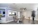 Dining area with a modern glass table, seating for six, and a contemporary ceiling fan at 7329 Restful Springs Ct, Las Vegas, NV 89128