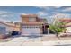 Inviting two-story home with tile roof, attached garage, and low-maintenance landscaping at 7329 Restful Springs Ct, Las Vegas, NV 89128