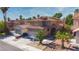 Beautiful two-story home featuring a tile roof, desert landscaping, and a spacious driveway with a two-car garage at 7329 Restful Springs Ct, Las Vegas, NV 89128