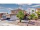 Charming two-story home with tile roof, low-maintenance landscaping, and a two-car garage at 7329 Restful Springs Ct, Las Vegas, NV 89128