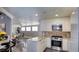 Bright kitchen featuring stainless steel appliances, granite countertops, and light wood cabinets at 7329 Restful Springs Ct, Las Vegas, NV 89128