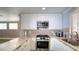 Modern kitchen with stainless steel oven, granite countertops, and white cabinets at 7329 Restful Springs Ct, Las Vegas, NV 89128