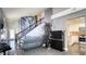 Open-concept living room with high ceilings, modern decor, and seamless flow to the kitchen and dining areas at 7329 Restful Springs Ct, Las Vegas, NV 89128