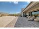 Paver patio with outdoor furniture, desert landscaping, and privacy provided by the back wall at 8838 Sorrel Hills Ct, Las Vegas, NV 89113
