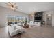 Elegant living room with a marble fireplace, comfortable seating, and large windows offering plenty of natural light at 8838 Sorrel Hills Ct, Las Vegas, NV 89113